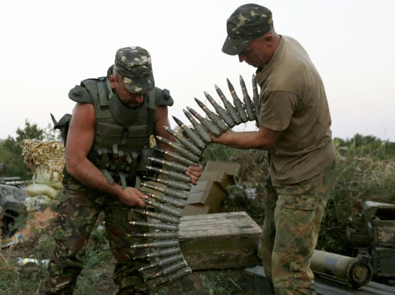 Ukrainian soldiers load ammunition at a checkpoint near Avdiivka, in the eastern Donetsk region, on August 23, 2015