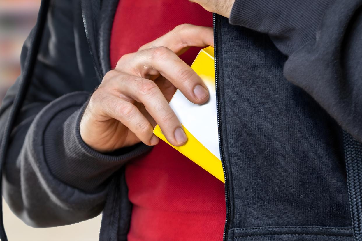 Retail Shoplifting. Man Stealing In Supermarket. Theft At Shop