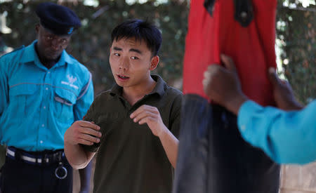 Chinese national Jack Wang a security trainer at the Chinese-run Deway Security Group leads Kenyan security guards in physical exercise during martial arts combat training at their company compound in Kenya's capital Nairobi, March 13, 2017. REUTERS/Thomas Mukoya