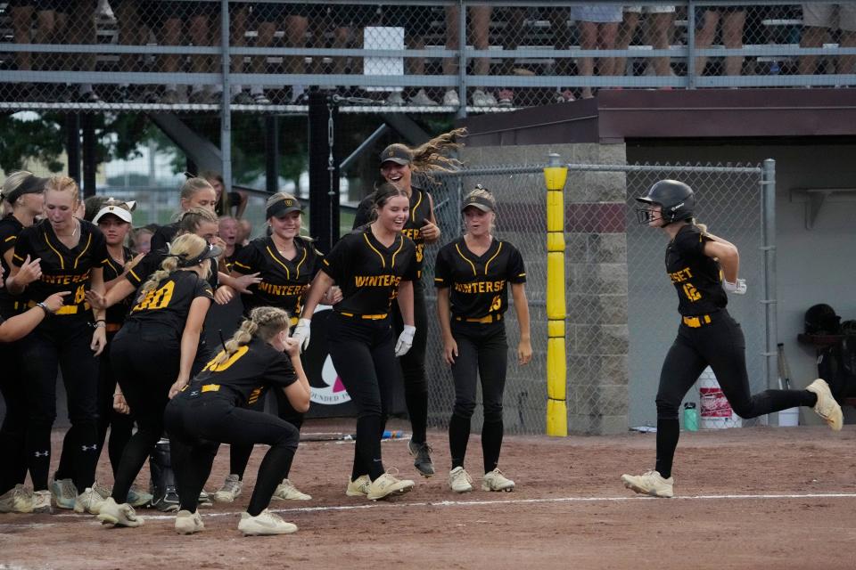 Winterset's Neela Applegate hits a home run during the Class 4A state softball championship against North Scott on Thursday. The Huskies won to claim their second straight title.