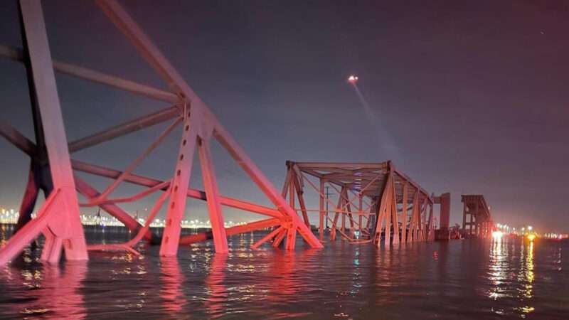 An image of the collapsed Francis Scott Key Bridge in Baltimore, Maryland as parts of the structure sit in the water