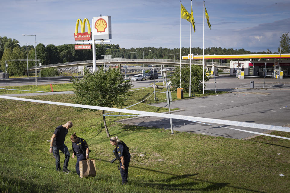 Police work at the site on Sunday Aug. 2, 2020 where a twelve-year-old girl was shot and killed near a petrol station in Botkyrka, south of Stockholm, Sweden. (Naina Helén Jåma/TT via AP)