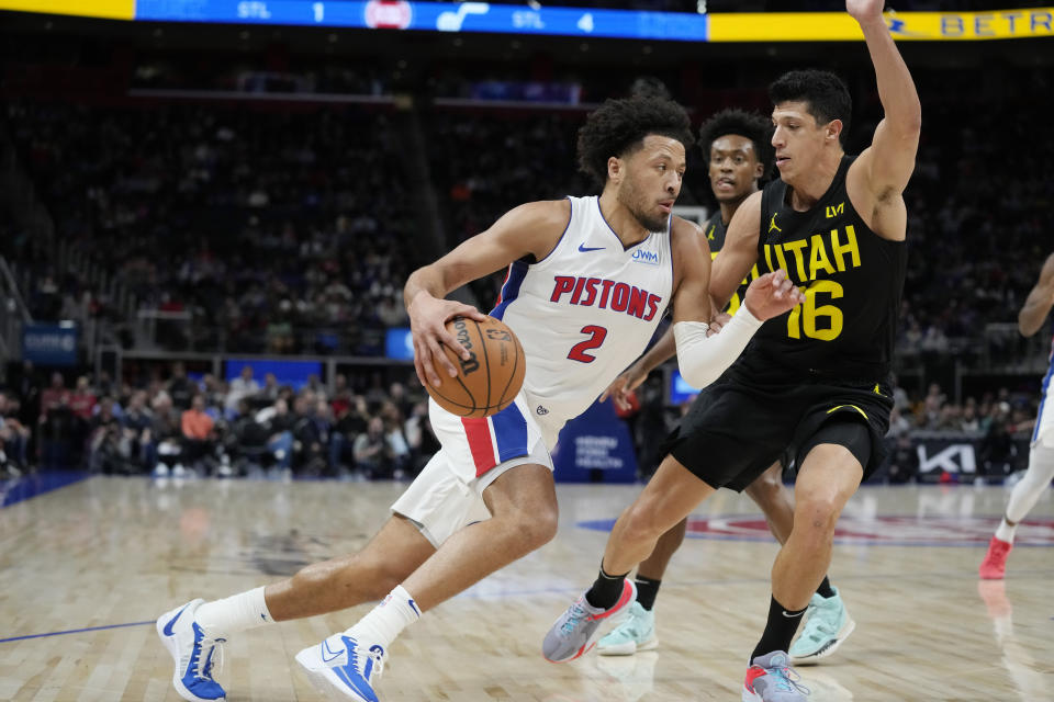 Detroit Pistons guard Cade Cunningham (2) drives as Utah Jazz forward Simone Fontecchio (16) defends during the first half of an NBA basketball game, Thursday, Dec. 21, 2023, in Detroit. (AP Photo/Carlos Osorio)