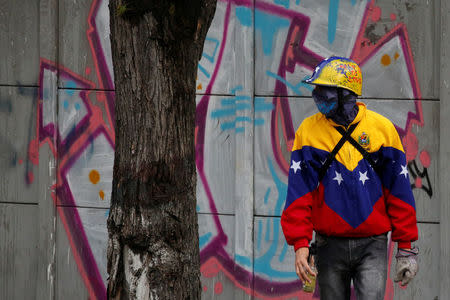 A demonstrator looks on while clashing with riot security forces during a rally against Venezuela's President Nicolas Maduro's government in Caracas, Venezuela, July 28, 2017. REUTERS/Carlos Garcia Rawlins