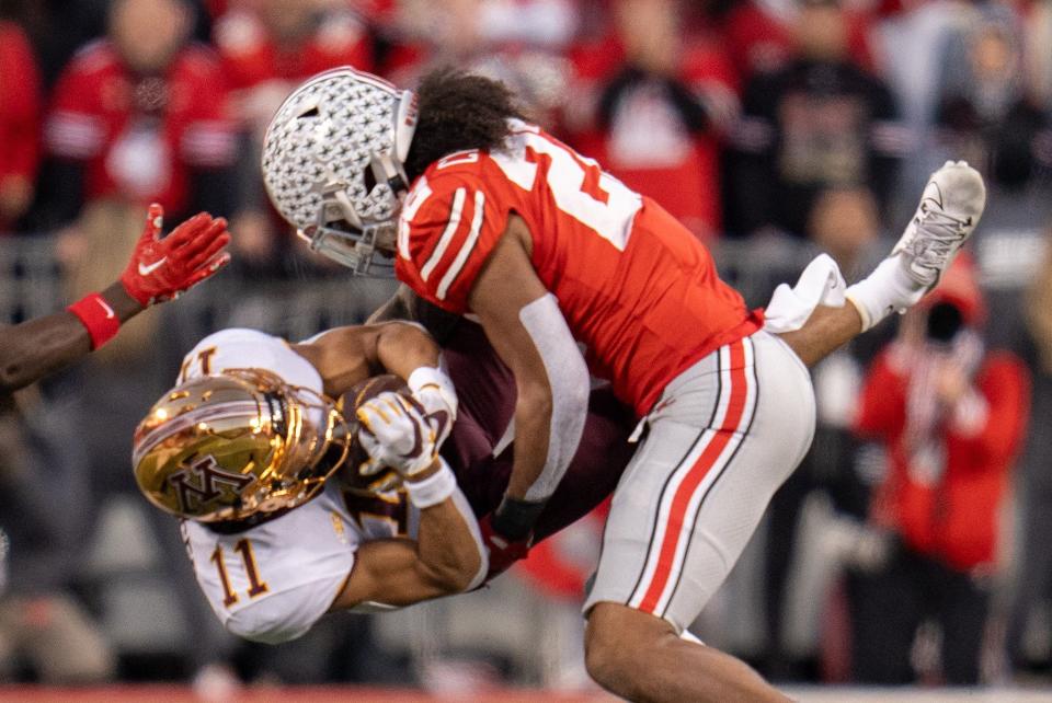 Nov 18, 2023; Columbus, Ohio, USA; 
Ohio State Buckeyes linebacker Steele Chambers (22) tackles Minnesota Golden Gophers wide receiver Elijah Spencer (11) during the first half of their game on Saturday, Nov. 18, 2023 at Ohio Stadium.