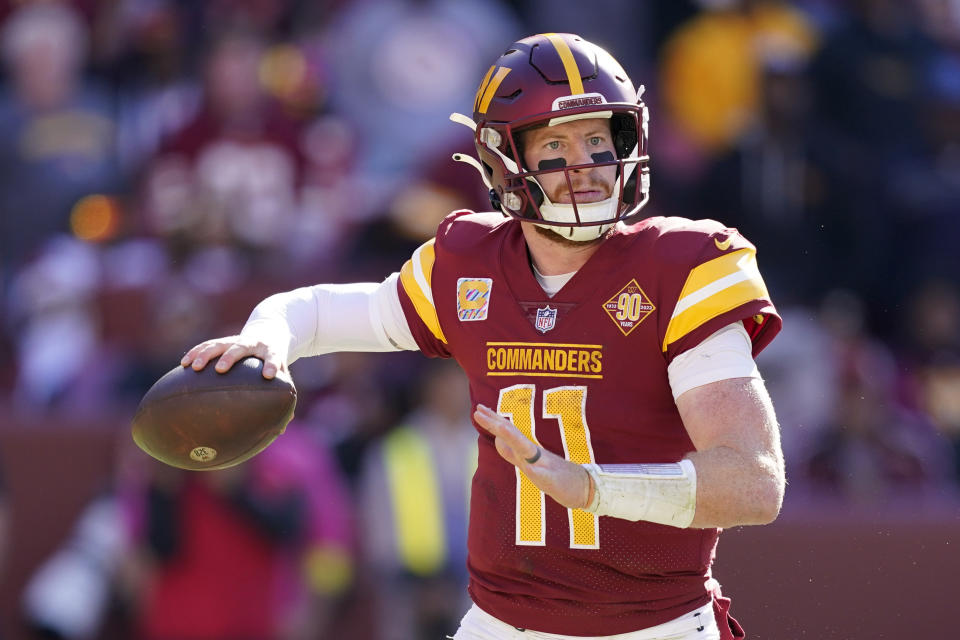 Washington Commanders quarterback Carson Wentz throws to a receiver in the second half of an NFL football game against the Tennessee Titans, Sunday, Oct. 9, 2022, in Landover, Md. (AP Photo/Alex Brandon)