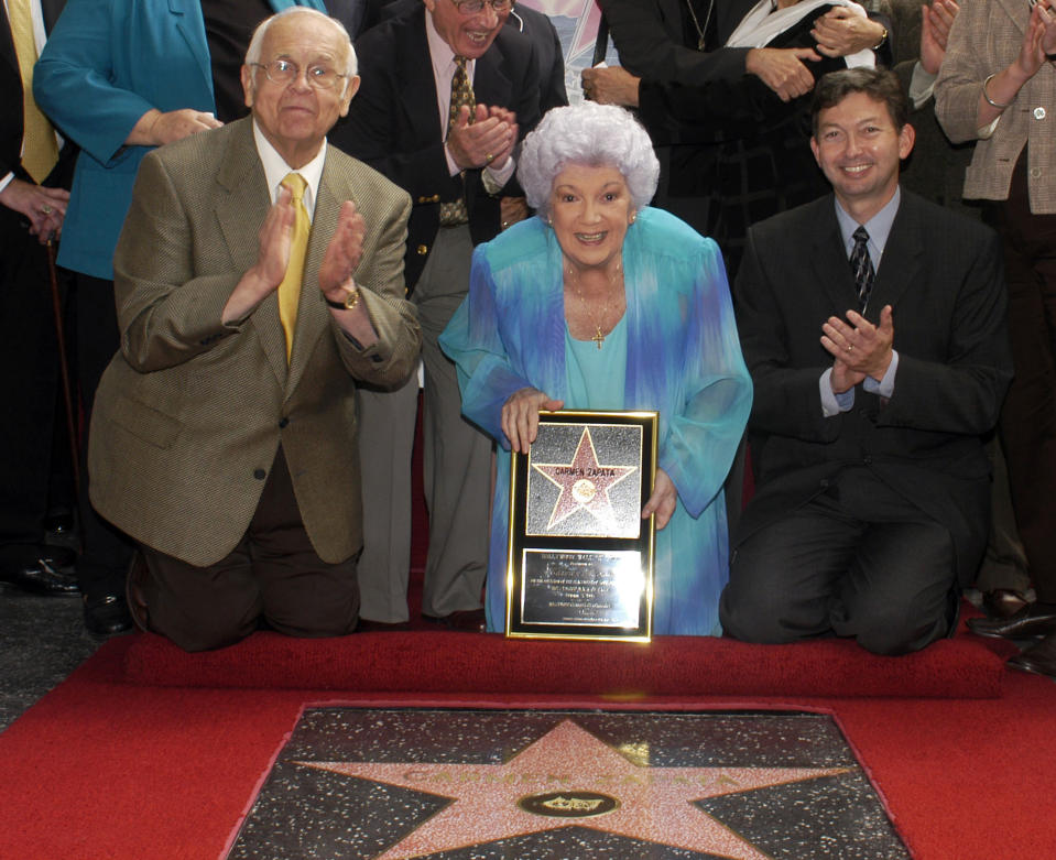 In this Oct. 2, 2003 photo provided by the Hollywood Chamber of Commerce, actress Carmen Zapata poses with honorary Hollywood mayor Johnny Grant, left, and chamber president Leron Gubler, right, as she receives her star on the Hollywood Walk of Fame in Los Angeles. Zapata died Sunday, Jan. 5, 2014, at her Los Angeles home, surrounded by family and friends. She was 86. Her death was announced Tuesday, Jan. 7, by Luis Vela at the Bilingual Foundation of the Arts, a Los Angeles organization that Zapata founded. Zapata started her career in 1945 in the Broadway musical "Oklahoma" and went on to perform in "Bells Are Ringing," "Guys and Dolls" and many plays. Her movie credits include "Sister Act," "Gang Boys" and "Carola," as well as dozens of television series. (AP Photo/Hollywood Chamber of Commerce, Bob Freeman)