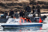 Tourists from the Chinese side of the Yalu River sail in front of a North Korean boat ferrying people north of the town of Sinuiju in North Korea and Dandong in China's Liaoning province, April 1, 2017. REUTERS/Damir Sagolj