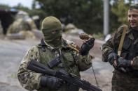 A Pro-Russian rebel holds a hand grenade at a checkpoint near the airport in Donetsk, eastern Ukraine, September 10, 2014. REUTERS/Marko Djurica