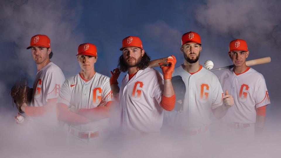 The San Francisco Giants in 2021 in their Nike City Connect jerseys, featuring assistant coach Alyssa Nakken and players Kevin Gausman, Brandon Crawford and Alex Wood.