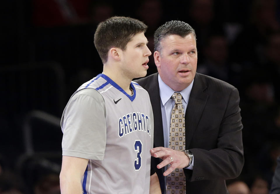 Creighton head coach Greg McDermott talks to Doug McDermott, left, during the first half of an NCAA college basketball game against Providence in the finals of the Big East Conference tournament Saturday, March 15, 2014, at Madison Square Garden in New York. (AP Photo/Frank Franklin II)