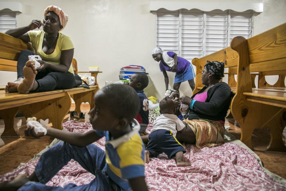 <p>Families gather at a shelter in a local church during the evening before the arrival of Hurricane Irma in Las Terrenas, Dominican Republic, Wednesday, Sept. 6, 2017. Dominicans wait for the arrival of Hurricane Irma after it lashed Puerto Rico with heavy rain and powerful winds, leaving nearly 900,000 people without power as authorities struggled to get aid to small Caribbean islands already devastated by the historic storm. ( Photo: Tatiana Fernandez/AP) </p>