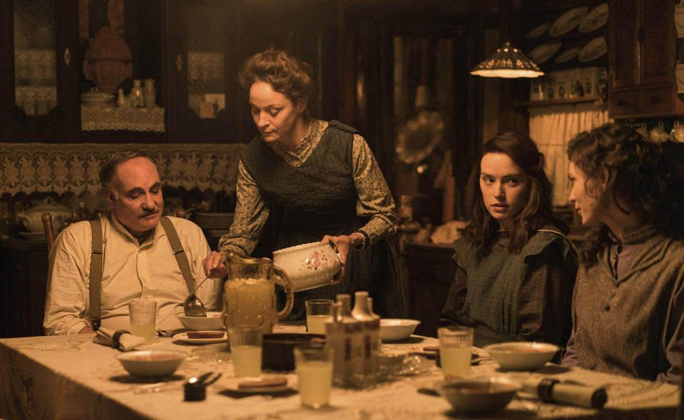 This image released by Disney shows, from left, Kim Bodnia as Henry Ederle, Jeanette Hain as Gertrud Ederle, Daisy Ridley as Trudy Ederle and Tilda Cobham-Hervey, as Meg Ederle, in a scene from "Young Woman and the Sea." (Disney via AP)