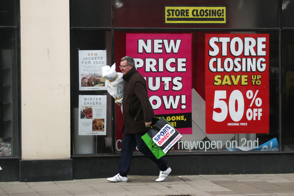A shopper walks past a high street store that is closing down in Worthing, Britain February 21, 2020. REUTERS/Russell Boyce