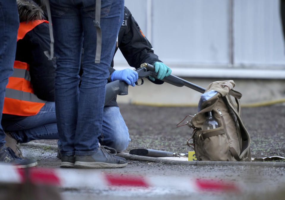 Police officers secure traces on the grounds of the Heidelberg University Botanical Garden in Heidelberg, Germany, Monday, Jan. 24, 2022. German police say a lone gunman wounded several people at a lecture theatre in the southwest city of Heidelberg on Monday. Police said in a brief statement that the perpetrator was dead but didn't give details of how that happened.(AP Photo/Michael Probst)