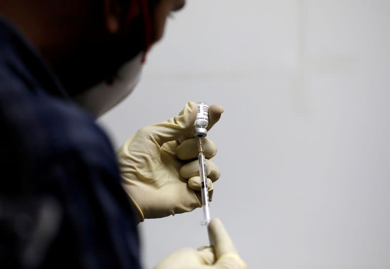 FILE PHOTO: A medic fills a syringe with COVAXIN, an Indian government-backed experimental COVID-19 vaccine, before administering it to a health worker during its trials, in Ahmedabad