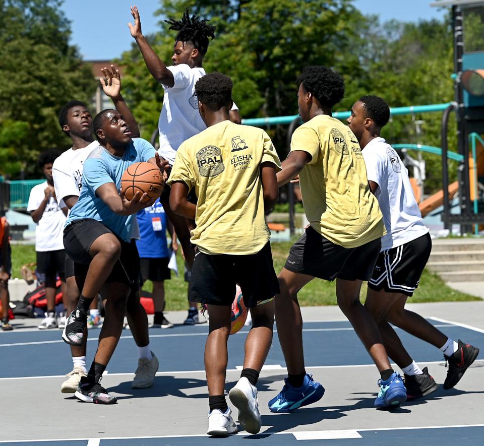 Boston teens play 3-3 basketball during the "Play 4 Peace" tournament at Harambee Park in Boston, July 30. The second annual event was created by a group of friends from Lincoln-Sudbury High School Class of 1988.