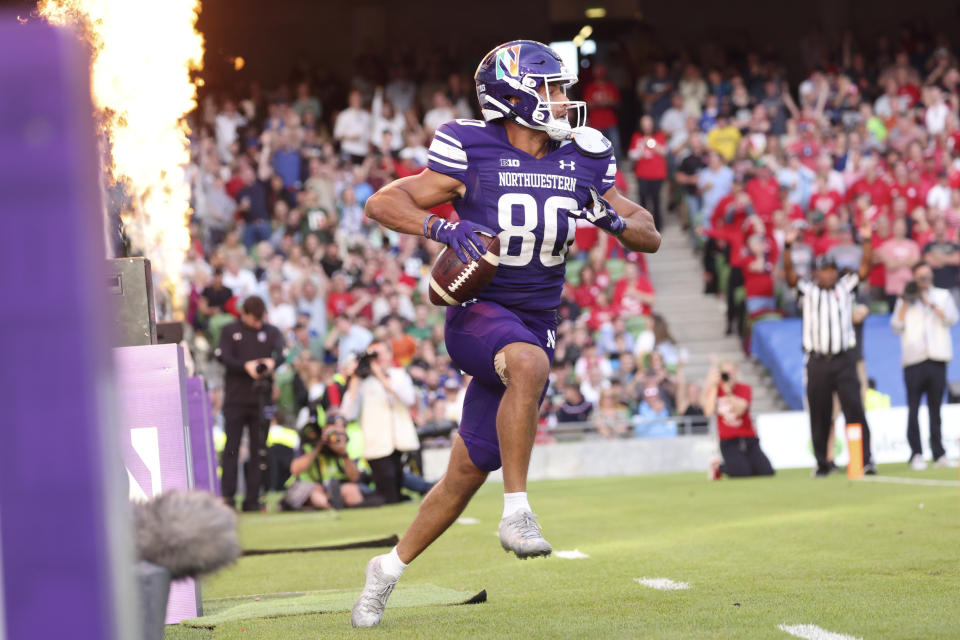 Northwestern wide receiver Donny Navarro III (80) celebrates after catching a 6-yard touchdown pass during the first half of an NCAA college football game against Nebraska, Saturday, Aug. 27, 2022, at Aviva Stadium in Dublin, Ireland. (AP Photo/Peter Morrison)