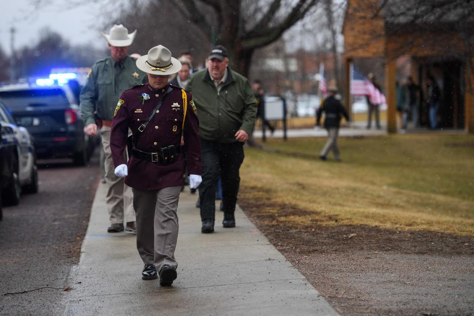 South Dakota Highway patrol officer leads next group of law enforcement into Prorok’s funeral on Thursday, Feb. 8, 2024 at Dakota State Fieldhouse in Madison, South Dakota.