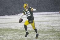 Green Bay Packers' Aaron Rodgers runs for a first down during the second half of an NFL football game against the Tennessee Titans Sunday, Dec. 27, 2020, in Green Bay, Wis. (AP Photo/Mike Roemer)