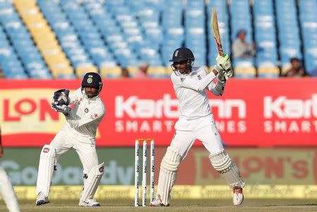Cricket - India v England - First Test cricket match - Saurashtra Cricket Association Stadium, Rajkot, India - 12/11/16. England's Haseeb Hameed plays a shot as India's wicketkeeper Wriddhiman Saha (L) looks on. REUTERS/Amit Dave