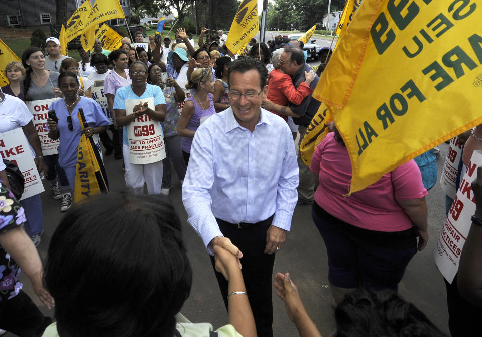 Connecticut Gov. Dannel P. Malloy meets with striking nursing home workers at Newington Health Care Center in Newington, Conn., Wednesday, July 11, 2012. Workers at five HealthBridge-owned nursing homes around the state went on strike last week after the health care company declined to return to the bargaining table. Malloy said it's clear the company has taken "unfair actions" against employees, citing last week's federal complaint against the company issued by the National Labor Relations Board. (AP Photo/Jessica Hill)