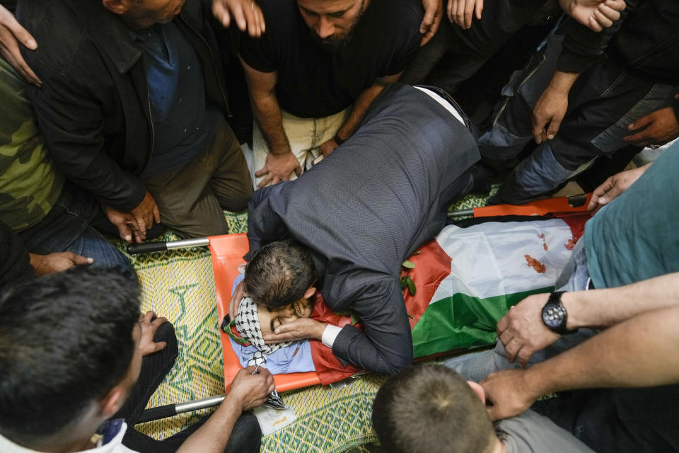 A Palestinian man kisses Yazan Shtayyeh,17, killed in an Israeli military raid, during his funeral in West Bank village of Salem, Near the Palestinian town of Nablus, Monday, April 15, 2024. (AP Photo/Majdi Mohammed)