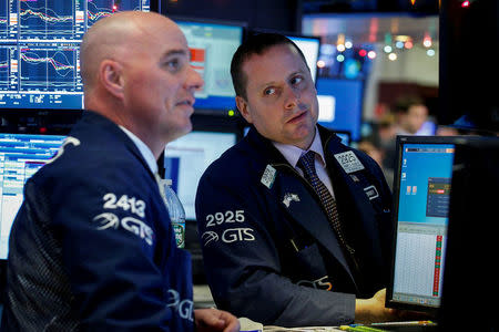 Traders work on the floor of the New York Stock Exchange (NYSE) in New York, U.S., December 6, 2017. REUTERS/Brendan McDermid
