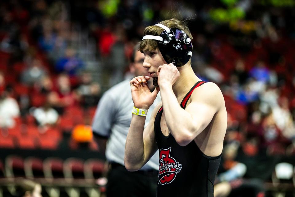 Fort Dodge's Dru Ayala puts on his headgear before wrestling at the Class 3A state tournament on Feb. 16. Ayala won the 120-pound title at the Dan Gable Donnybrook this past weekend.