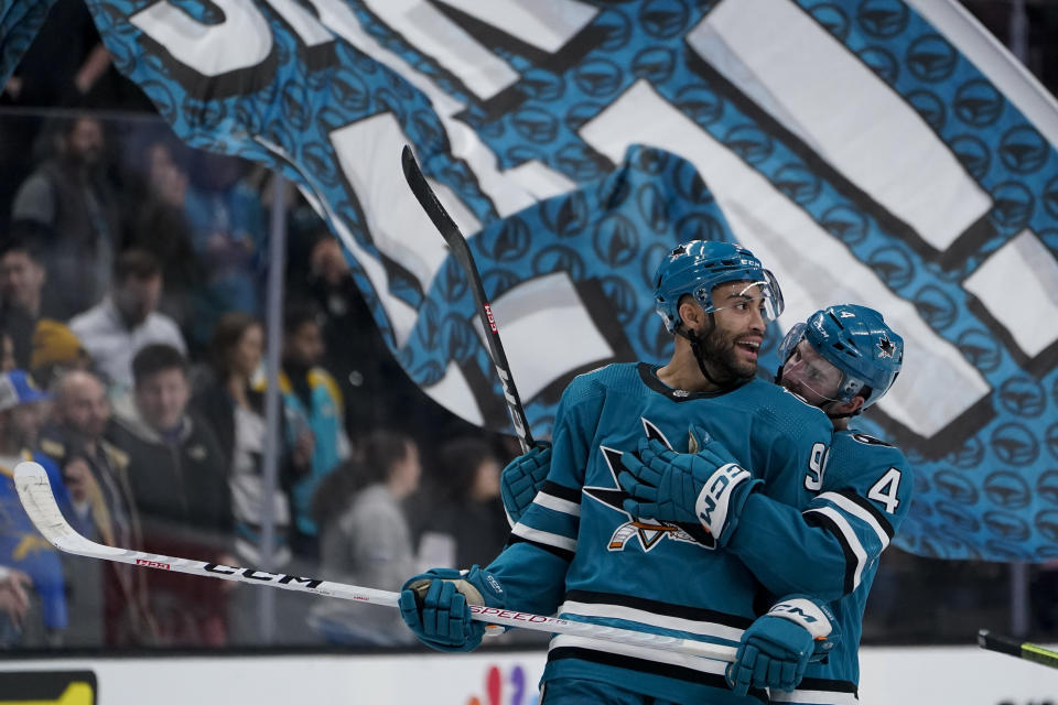 San Jose Sharks right wing Justin Bailey, left, and defenseman Kyle Burroughs celebrates after the team's victory over the Winnipeg Jets in an NHL hockey game Tuesday, Dec. 12, 2023, in San Jose, Calif. (AP Photo/Godofredo A. Vásquez)