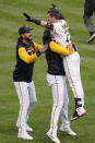 Pittsburgh Pirates' Kevin Newman, right, celebrates with teammates after hitting the game-winning RBi single off of Cincinnati Reds relief pitcher Alexis Diaz in the 10th inning of a baseball game in Pittsburgh, Wednesday, Sept. 28, 2022. The Pirates won 4-3 in 10 innings. (AP Photo/Gene J. Puskar)