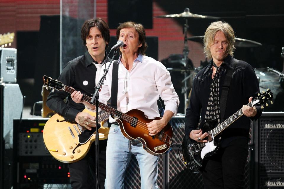 This image released by Starpix shows Paul McCartney, center, at the 12-12-12 The Concert for Sandy Relief at Madison Square Garden in New York on Wednesday, Dec. 12, 2012. Proceeds from the show will be distributed through the Robin Hood Foundation. (AP Photo/Starpix, Dave Allocca)