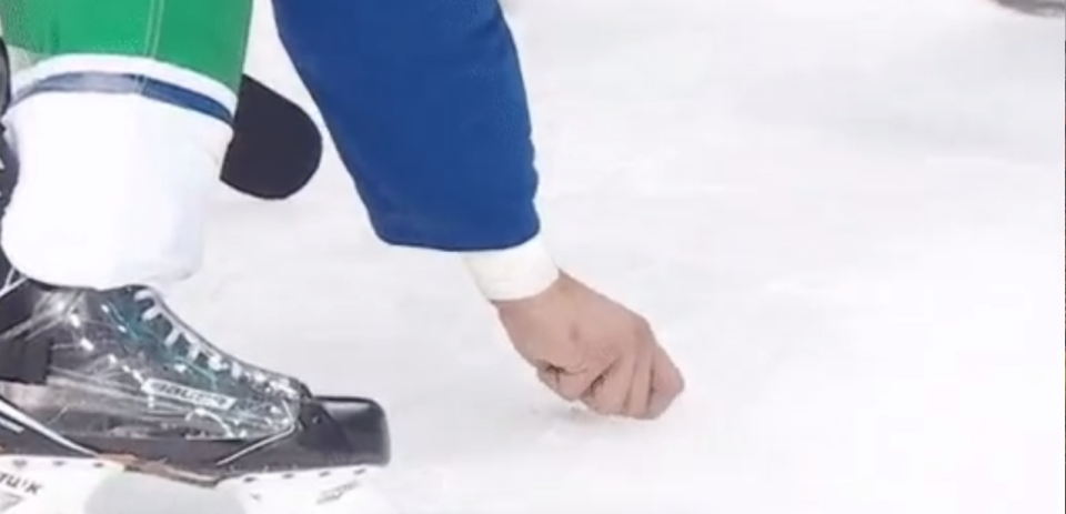 It takes a quality D-partner to pick your bloody teeth off the ice. (Vancouver Canucks/Twitter)