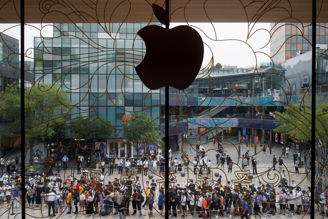 People line up outside the new Apple flagship store on its opening day following an outbreak of the coronavirus disease (COVID-19) in Sanlitun in Beijing, China, July 17, 2020. REUTERS/Thomas Peter