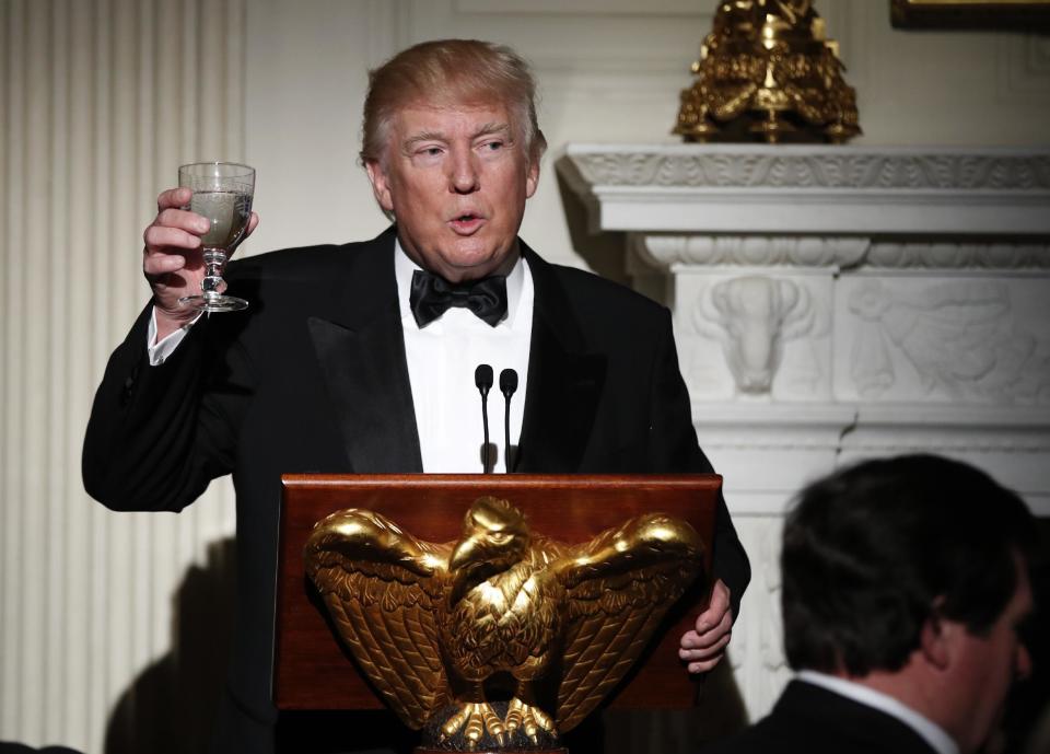 Host President Donald Trump, makes a toast during a dinner reception for the annual National Governors Association winter meeting Sunday, Feb. 26, 2017, at the State Dining Room of the White House, in Washington. (AP Photo/Manuel Balce Ceneta)