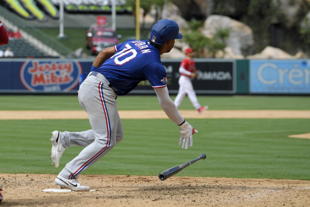 Texas Rangers outfielders Charlie Culberson, left, Leody Taveras