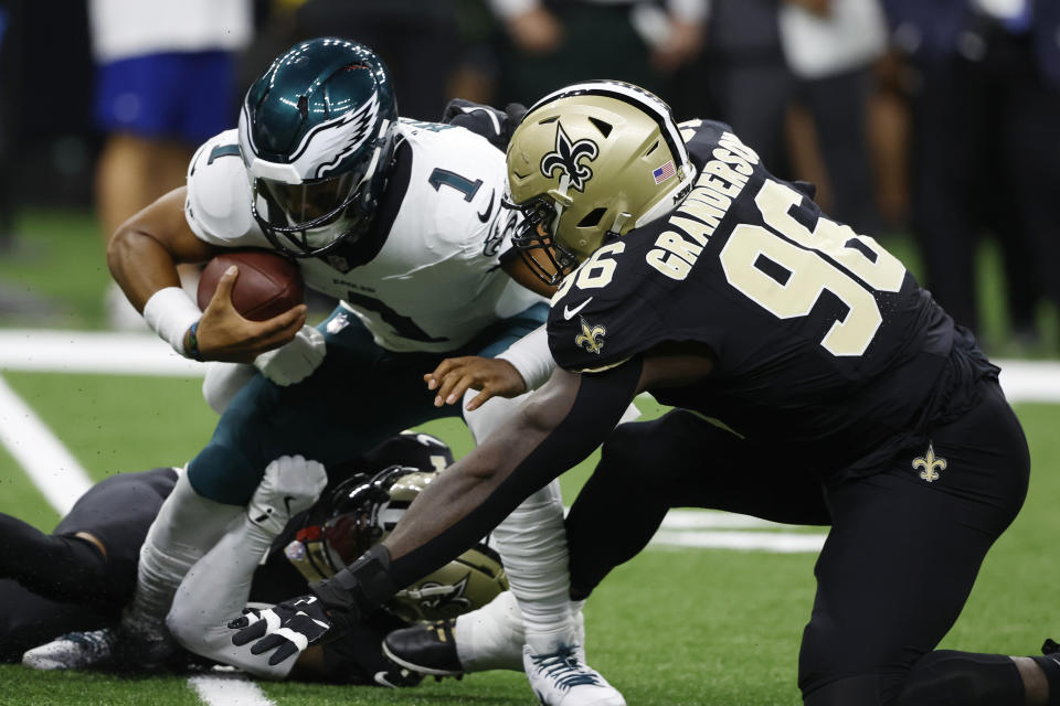 Philadelphia Eagles quarterback Jalen Hurts (1) is sacked by New Orleans Saints defensive end Carl Granderson (96) in the first half of an NFL football game in New Orleans, Sunday, Sept. 22, 2024. (AP Photo/Butch Dill)