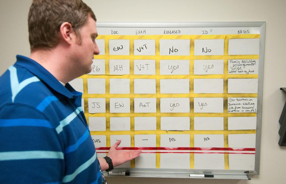 First Deputy Montgomery County Coroner Alex Balacki talks about the freezer board at the coroner's office Friday, March 9, 2018 in Norristown. This is where they keep track of remains stored in their freezer. [BILL FRASER / STAFF PHOTOJOURNALIST]