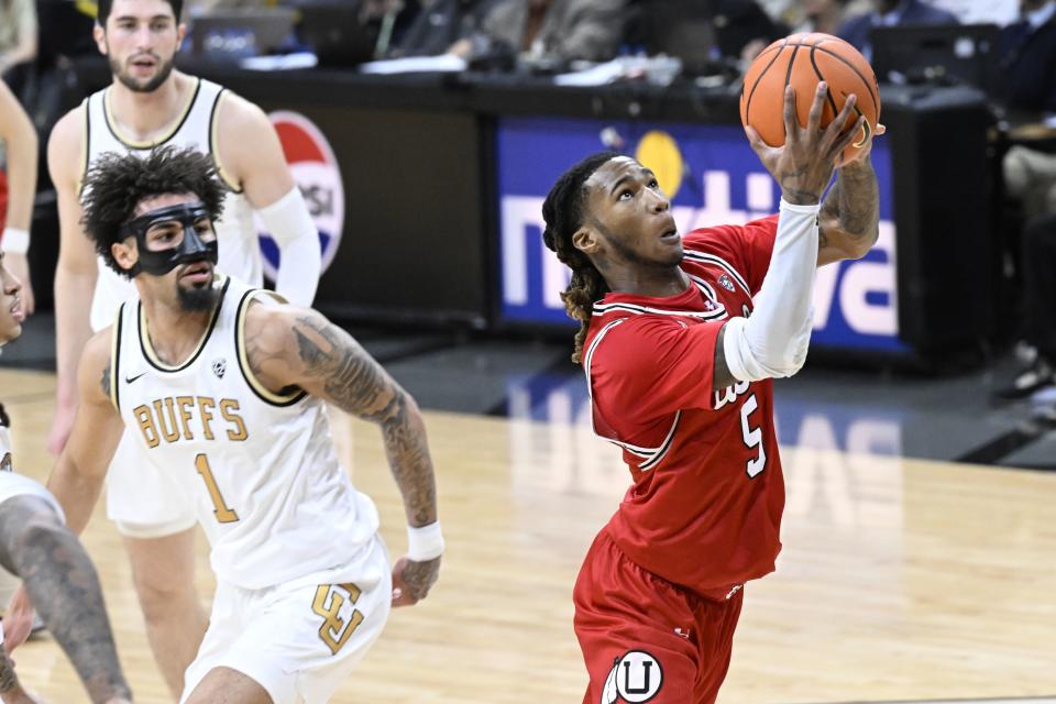Utah guard Deion Smith, right, heads to the basket past Colorado guard J’Vonne Hadley (1) in the second half of an NCAA college basketball game Saturday, Feb. 24, 2024, in Boulder, Colo. | Cliff Grassmick, Associated Press