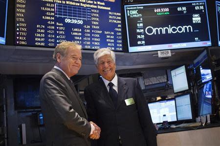 Omnicom Chief Executive John Wren (L) and Publicis Group Chairman and CEO Maurice Levy shake hands after announcing an agreement on their merger on the floor of the New York Stock Exchange in New York July 29, 2013. REUTERS/Shannon Stapleton