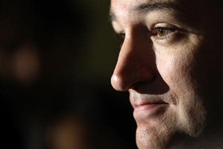 Reporters gather around U.S. Senator Ted Cruz (R-TX) as he announces he will not filibuster, after a Republican Senate caucus meeting at the U.S. Capitol in Washington, October 16, 2013. REUTERS/Jonathan Ernst