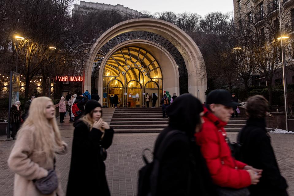 People walk past the entrance of a cable car station on Feb. 15, 2022, in Kyiv, Ukraine.