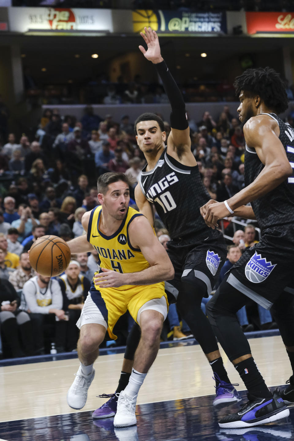 Indiana Pacers guard T.J. McConnell (9) works around Sacramento Kings guard Justin James (10) during the second half of an NBA basketball game in Indianapolis, Friday, Dec. 20, 2019. The Pacers won 119-105. (AP Photo/AJ Mast)