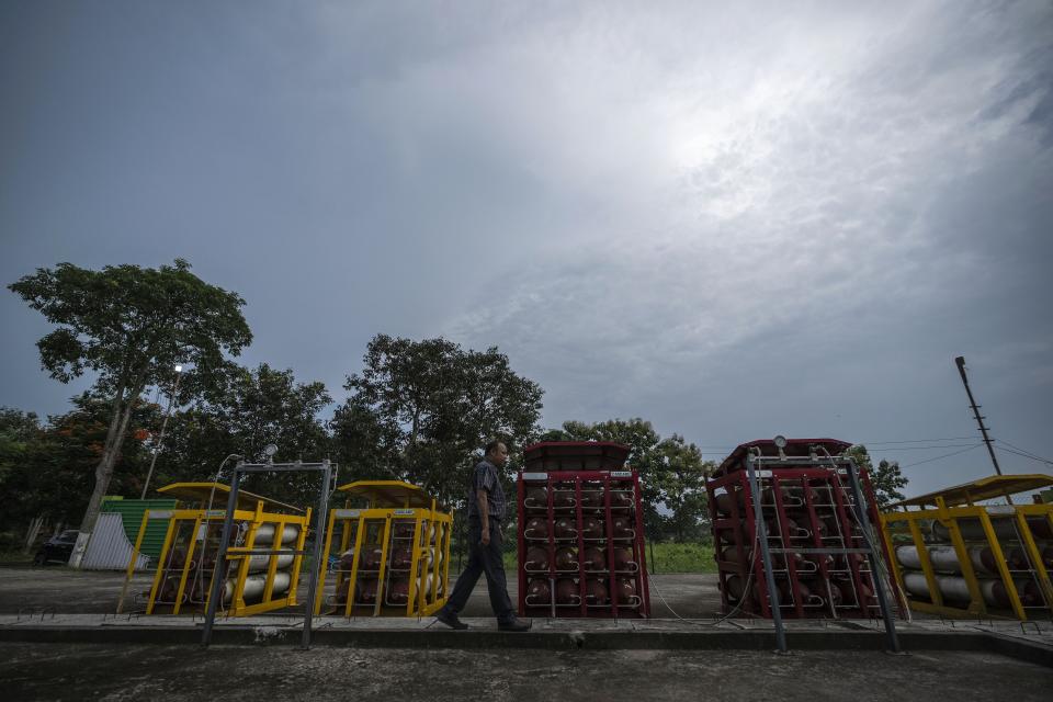 P V R Murthy, general manager at Oil India Limited, walks by part of a hydrogen plant in Jorhat, India, Thursday, Aug. 17, 2023. Green hydrogen is being touted around the world as a clean energy solution to take the carbon out of high-emitting sectors like transport and industrial manufacturing. (AP Photo/Anupam Nath)