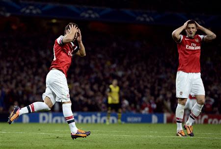 Arsenal's Santi Cazorla (L) and Olivier Giroud react after a missed opportunity during their Champions League soccer match against Borussia Dortmund at the Emirates stadium in London October 22, 2013. REUTERS/Dylan Martinez