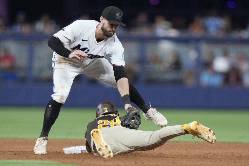 Miami Marlins shortstop Jon Berti tags out San Diego Padres pinch runner Jose Azocar as he attempted to steal second base during the eighth inning of a baseball game, Tuesday, May 30, 2023, in Miami. (AP Photo/Wilfredo Lee)