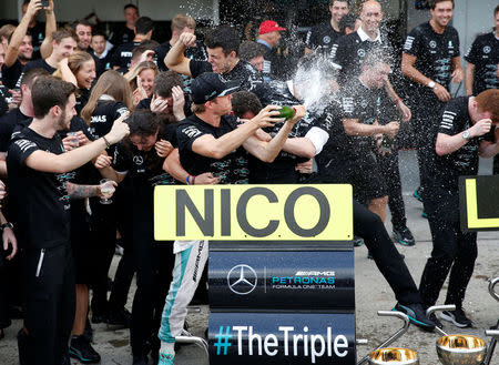 Formula One - Japanese Grand Prix - Suzuka Circuit, Japan- 9/10/16. Mercedes' driver Nico Rosberg of Germany celebrates with team members after they won the Constructors' Championship title for the 2016 season after the race. REUTERS/Toru Hanai