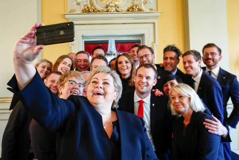 Norway's Prime Minister Erna Solberg takes a selfie with her new government in Oslo