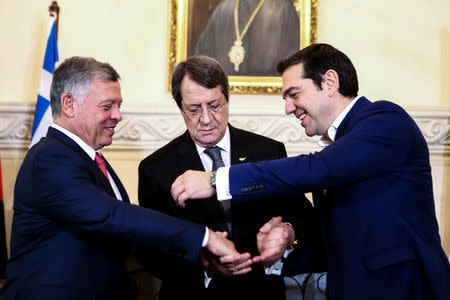 Cypriot President Nicos Anastasiades (C), Greek Prime Minister Alexis Tsipras and Jordan's King Abdullah shake hands during a meeting at the Presidential Palace in Nicosia, Cyprus January 16, 2018. REUTERS/ Iakovos Hatzistavrou/Pool