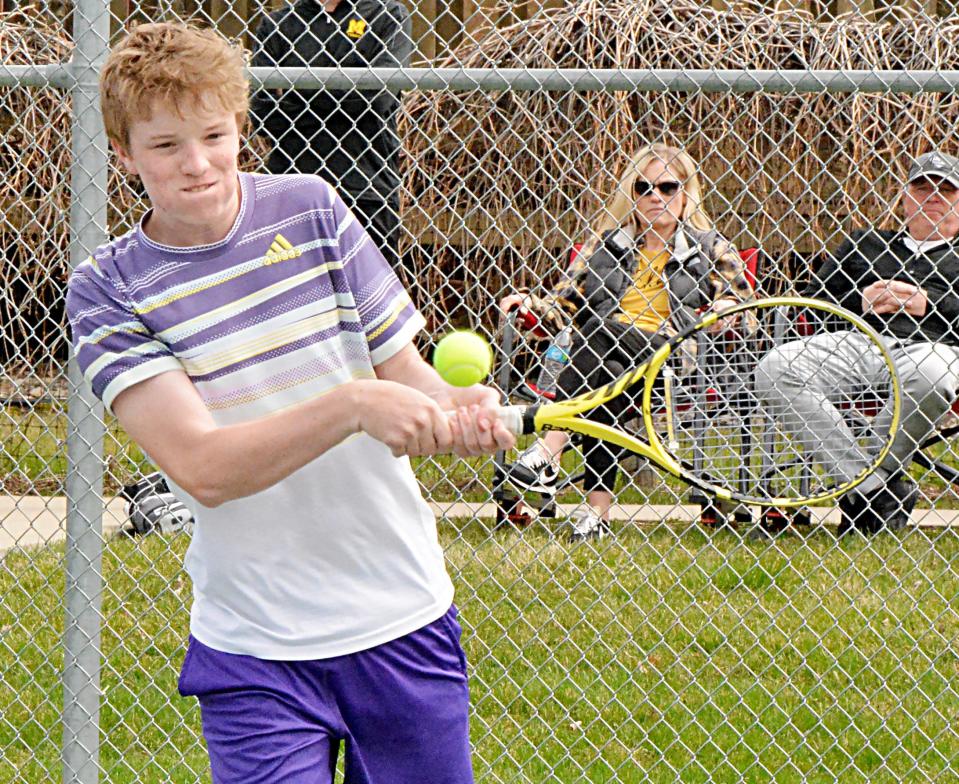 Watertown's Curtis Sneden hits a backhand return Friday during a high school boys tennis dual against Mitchell at the Highland Park Courts. Mitchell won 7-2.